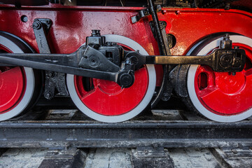 Red wheels of steam train, detail of old locomotive