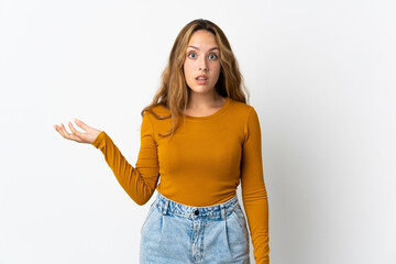 Young blonde woman isolated on blue background making doubts gesture
