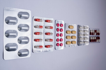 Pharmaceutical medicament, cure in container for health. Pharmacy theme, capsule pills. Various drugs: tablets, blister-packed tablets, pharmaceuticals.