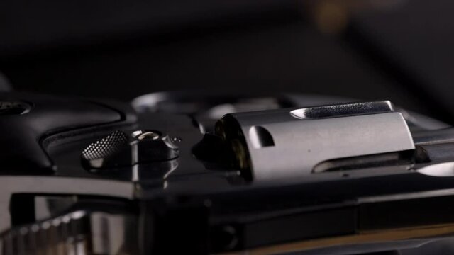 Revolver on rotating table - Low key lighting of polished steel and barell