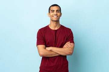 African American man over isolated background keeping the arms crossed in frontal position