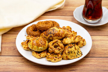 Sesame crackers cookies on plate with cup of tea. Tasty cookie. Close up