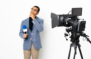 Reporter African American man holding a microphone and reporting news over isolated white background having doubts