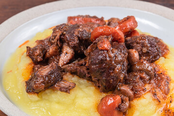 Beef burgundy with mashed potatoes, serving in a plate, close-up