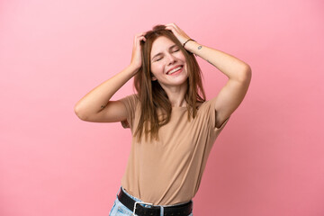 Young English woman isolated on pink background laughing
