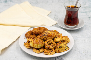 Sesame crackers cookies on plate with cup of tea. Tasty cookie. Close up