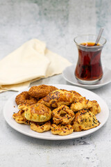 Sesame crackers cookies on plate with cup of tea. Tasty cookie. Close up