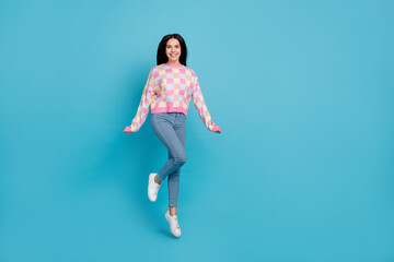 Fototapeta na wymiar Photo of shiny funny lady dressed print pullover jumping high empty space isolated blue color background