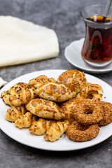 Sesame crackers cookies on plate with cup of tea. Tasty cookie. Close up