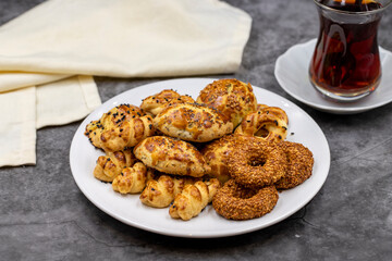 Sesame crackers cookies on plate with cup of tea. Tasty cookie. Close up
