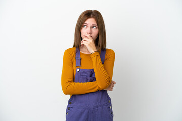 Young English woman isolated on white background having doubts and with confuse face expression