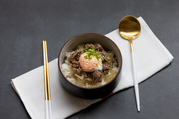 japanese style stir fried sliced pork with onsen egg on rice