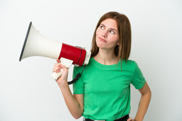 Young English woman isolated on white background holding a megaphone and thinking