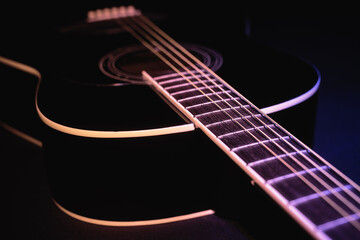 Fototapeta premium black guitar split colored concept. guitar music dark shoot