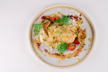Sturgeon steak and risotto with marinated black truffles and artichokes.