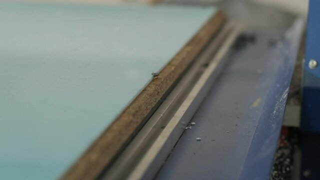 Production of advertising signs in the factory. Screwdriver tightens the screw