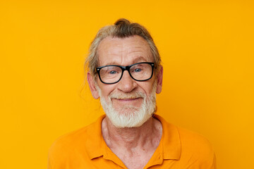 cheerful old man gray beard glasses yellow background