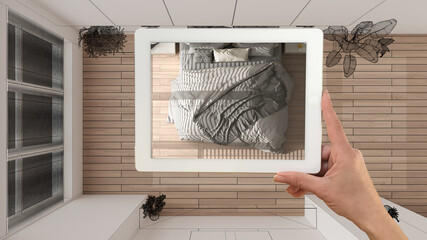Augmented reality concept. Hand holding tablet with AR application used to simulate furniture products in custom architecture design, black ink sketch, bedroom, top view, plan, above