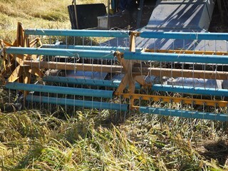 Harvester in the rice field. closeup photo, blurred.