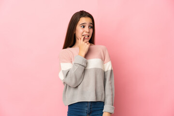 Little girl isolated on pink background nervous and scared