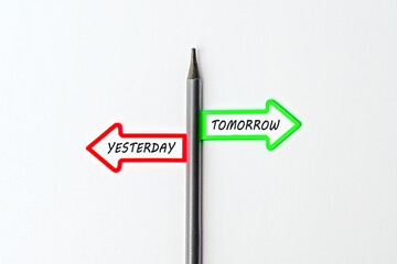 Tomorrow vs yesterday. Red arrow and green arrow- direction indicator - choice of Tomorrow or yesterday. Concept of choice. Two Arrows and pencil on white background