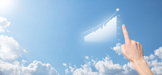 Business man holding tablet and showing holographic graphs and stock market statistics gain profits. Concept of growth planning and business strategy. Display of good economy form digital screen.