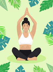 Woman doing yoga in lotus position against the background of tropical leaves and flowers