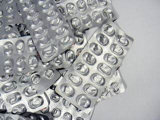 Used pill pack on white background with copy space. Tablets in foil packaging. Concept of healthcare, pharmacy and medicine. Empty medicine packaging. top view    