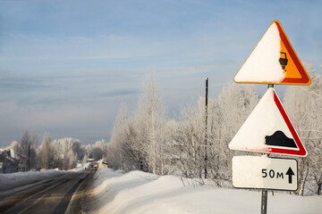 Snow covered road sign on a country road
