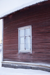 Red wooden building in snowy landscape