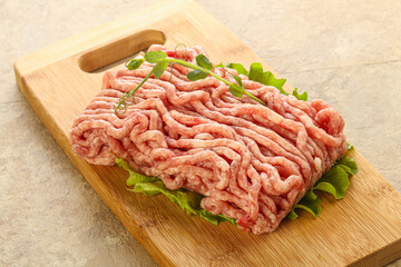 Raw minced pork meat over board