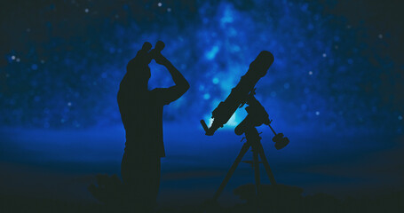 Obraz na płótnie Canvas Amateur astronomer searching stars and planets on a night sky with telescope and binoculars.