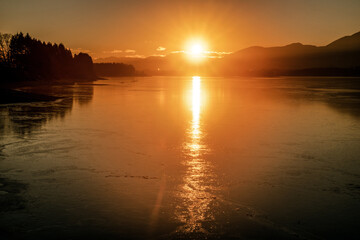 A beautiful sunrise on a dam Liptovska Mara. Beautiful morning in Slovakia. Winter landscape in bright warm dramatic colors