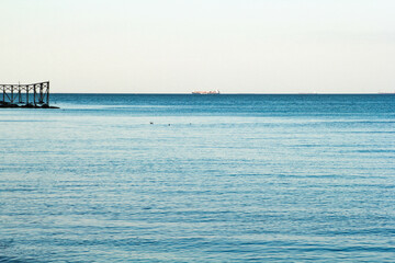Still clear blue sea and sky background view