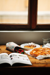 Delicious breakfast with fresh pastries, scrambled eggs, yogurt, croissants and strawberries in the apartment