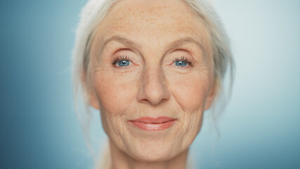 Medium Portrait of Beautiful Senior Woman Looking at Camera and Smiling Wonderfully. Gorgeous...