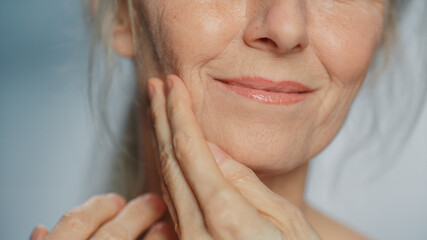 Anonymous Senior Woman Touching Her Neck, Chest, with Sensual Movement of Hands, Enjoying Soft Skin. Elderly Female Natural Beauty. Dignity and Grace in Old Age. Concept for Skin care, Healthy Living