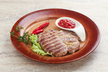 Grilled pork neck steak with ketchup