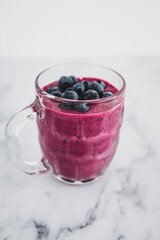 raspberry and dragonfruit smoothie with blueberries topping in pint glass