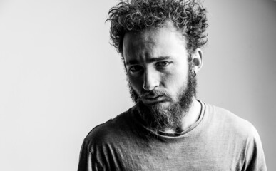 Fototapeta premium Young Man in Deep Drama Thinks how to Solve his Problems, Depression, Apathy. Depressed Guy, Black and White. Close-up. Copy Space 