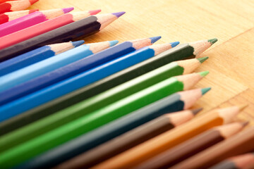 Line of Pencils on Wooden Surface