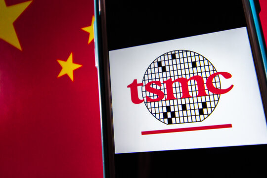 Kumamoto, JAPAN - Apr 20 2021 : The logo of Taiwan Semiconductor Manufacturing Company, Limited (TSMC) on iPhone on Chinese flag.