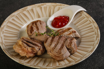 Grilled pork tenderlion with tomato sauce