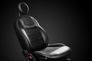 Ergonomic driver car seat with round headrest isolated on black background