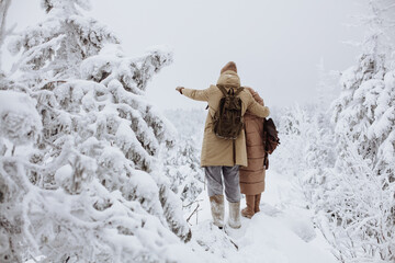 Loving couple of travelers in the covered mountains