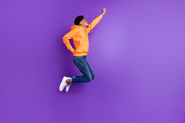 Fototapeta na wymiar Full length body size view of attractive cheery guy jumping striving success isolated over bright violet purple color background