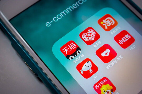 Kumamoto, JAPAN - May 17 2021 : The icons of popular e-commerce platforms in China (Tmall, Pinduoduo, JD.com, Kaola, Little Red Book Xiaohongshu, Taobao and Suning) on iPhone.