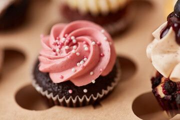 Cupcake with pink raspberry cream and sugar balls