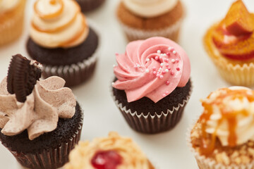 Different colorful small cupcakes with decoration