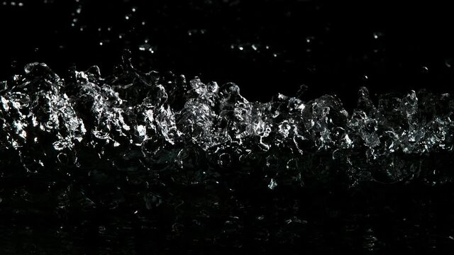 Super slow motion of impact hit of splashing water, close-up. Filmed on high speed cinema camera, 1000 fps.